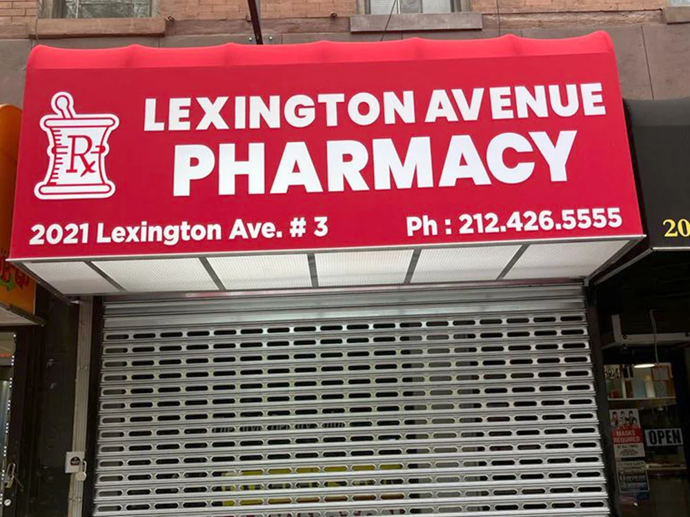 Red pharmacy awning signage for storefront