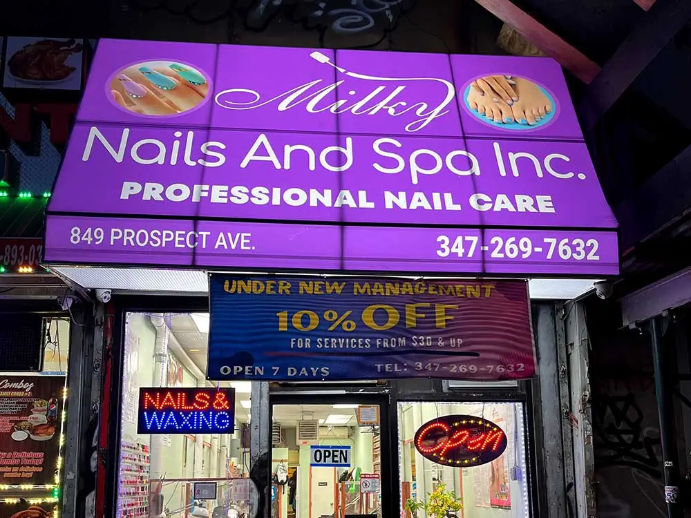 Nail salon awning with illuminated branding