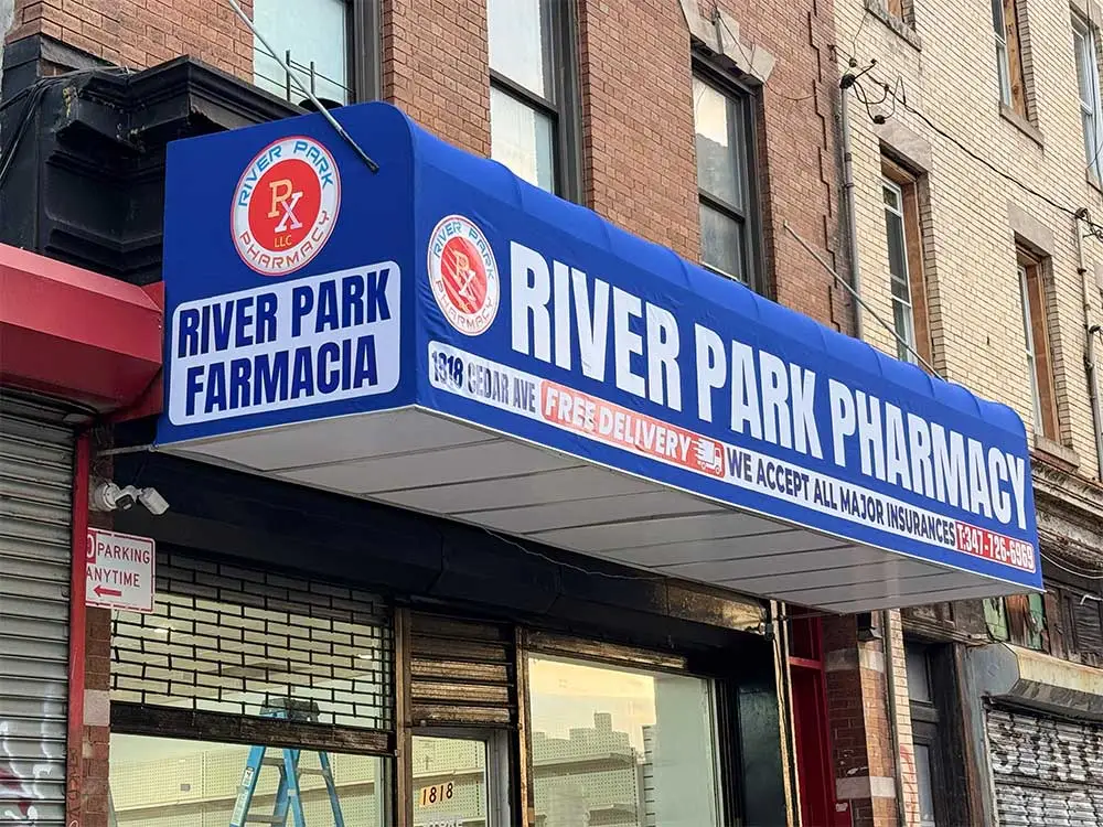Blue pharmacy awning installed on storefront