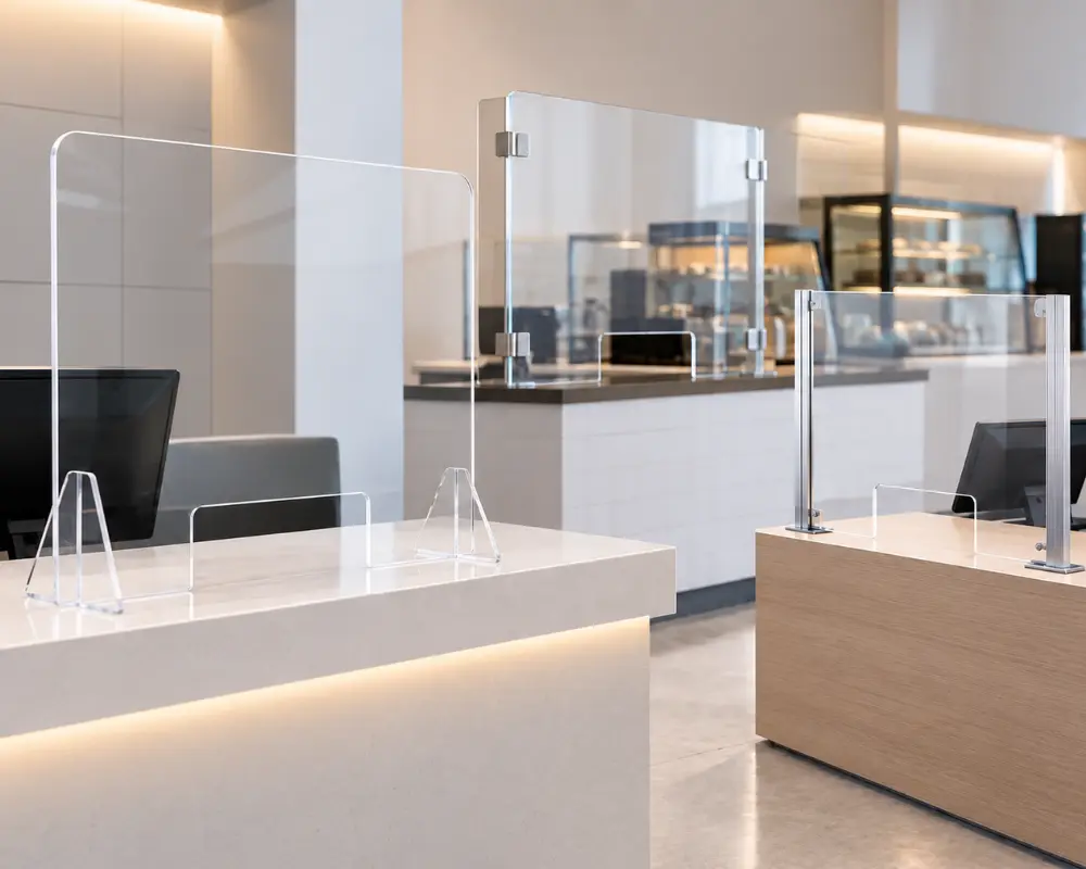 Transparent sneeze guard glass on reception desk